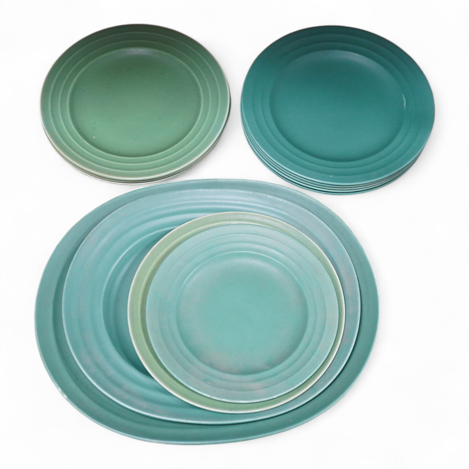 Keith Murray for Wedgwood, Annular part service comprising plates and two oval serving dishes, largest 38cm wide